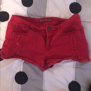 Red ripped shorts